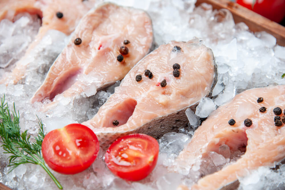 close-up-view-raw-fish-slices-with-ice-tomato-slices